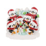 Ice fishing penguin family ornament for six with penguins in Santa hats gathered around an ice hole with fish and snowy mountains.