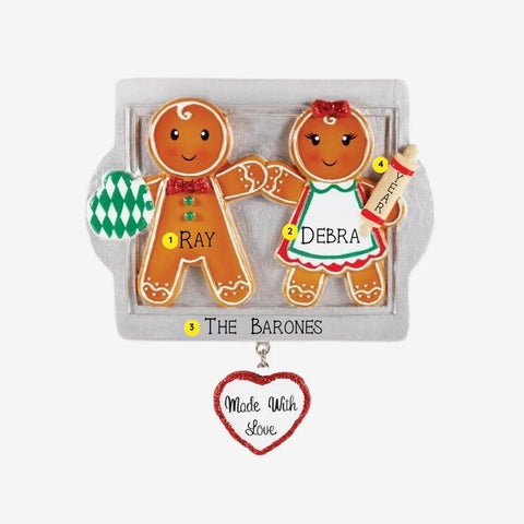Personalized Made With Love couple ornament with two gingerbread cookies on a silver baking tray, names, year, family name, oven mitt, and rolling pin.