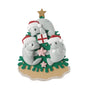 Manatee family ornament for three with manatees in Santa hats around a coastal Christmas tree with a gold star topper.