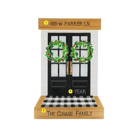 Personalized modern black front door ornament with an address on the top wood trim, family name on the bottom trim, and year added near the doors.