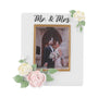 White Mr. & Mrs. wedding picture frame ornament with pastel flowers, green leaves, a gold photo border, and a blank gold banner.