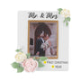 White Mr. & Mrs. wedding picture frame ornament with pastel flowers, a couple’s photo, and example personalization on the banner with a year.