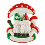Christmas ornament with two gnomes under a red and white mushroom on a white background