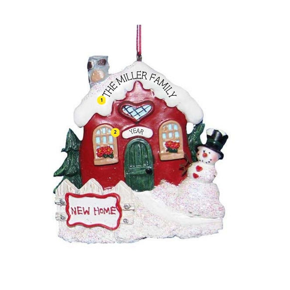 Personalized New Home Snowy Cottage Ornament with red cottage, green door, snowy roof, snowman, and New Home sign.