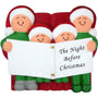 Decorative ornament of a family of four  in Santa hats holding a book titled 'The Night Before Christmas'.