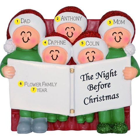 Family of 5 Ornament sitting on the couch reading the Night Before Christmas wearing santa hats on a background personalized with names and year. 
