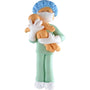 Ornament of a person in medical scrubs holding a baby, both wearing masks on a white background