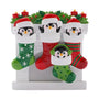 Penguin family of four ornament with festive Christmas stockings, Santa hats, candles, and holly.