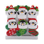 Penguin family of six ornament with mismatched Christmas stockings, Santa hats, holly, and candles.