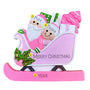 This playful design features Santa riding in a bright pink sleigh filled with colorful gifts and a festive tree, with a smiling helper riding along. 