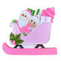 This playful design features Santa riding in a bright pink sleigh filled with colorful gifts and a festive tree, with a smiling helper riding along. 