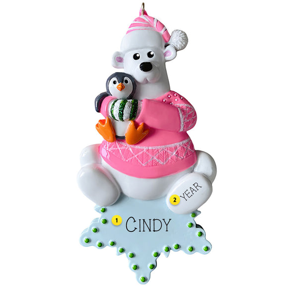 Decorative ornament with a polar bear and penguin holding a gift, on a white background.