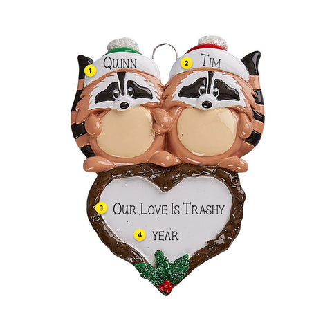 Two raccoons with personalized names on a heart-shaped ornament  can be personalized.