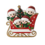 Red sleigh family ornament for four with glitter Santa hats, a Christmas tree, holly, and gold runners.
