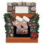 Decorative Christmas ornament of a stone fireplace with stockings and presents.
