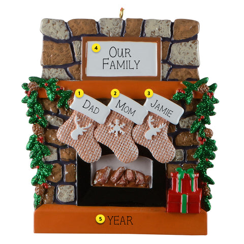 Decorative Christmas ornament of a fireplace with stockings and personalized names.
