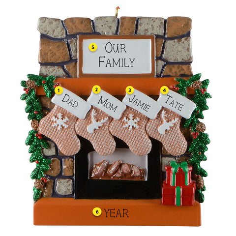 Personalized Christmas ornament with stockings and family names against a stone fireplace background.