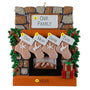 Personalized Christmas ornament with stockings and family names against a stone fireplace background.