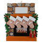 Decorative Christmas ornament of a fireplace with stockings and a present.