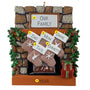Personalized Christmas ornament with family names on stockings against a stone fireplace background.