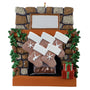 Decorative Christmas ornament of a stone fireplace with stockings and wreaths.
