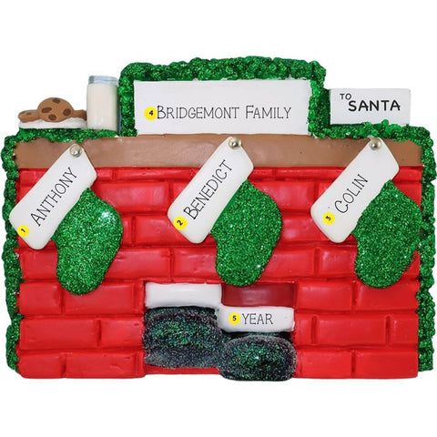 Christmas ornament of a mantel with personalized stockings against a white background