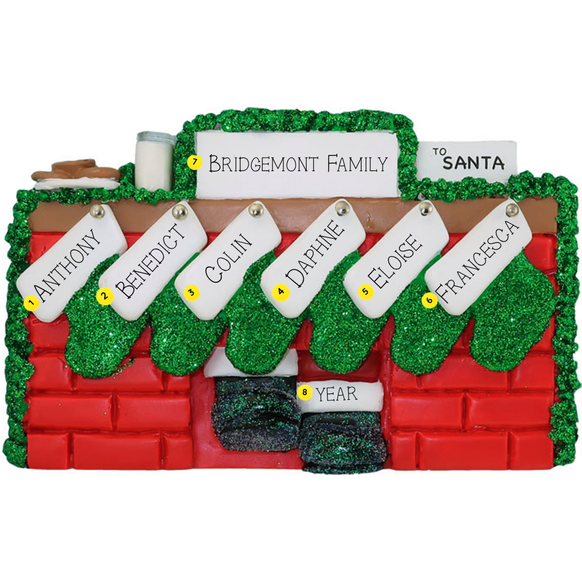 Christmas ornament of a mantel personalized with names, year, & family name against a white background