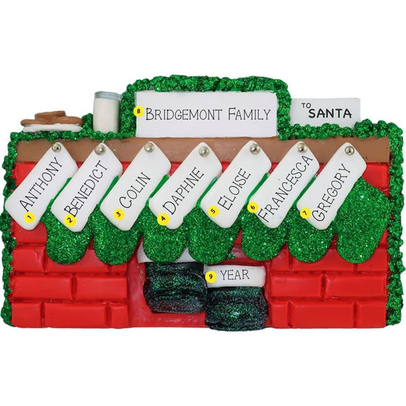 Christmas ornament of a mantel personalized with names, year, & family name against a white background
