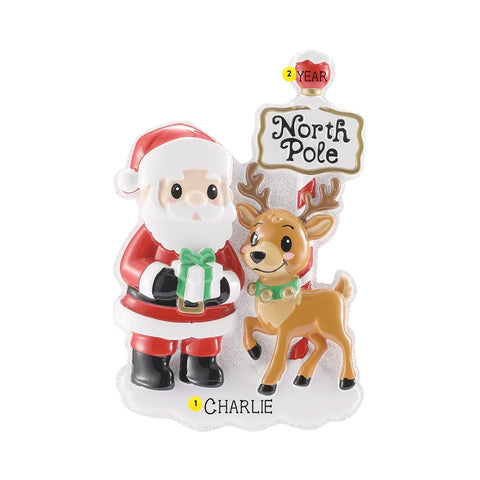 Personalized Santa and reindeer at the North Pole ornament with a name on the snowy base and year on the red sign topper.
