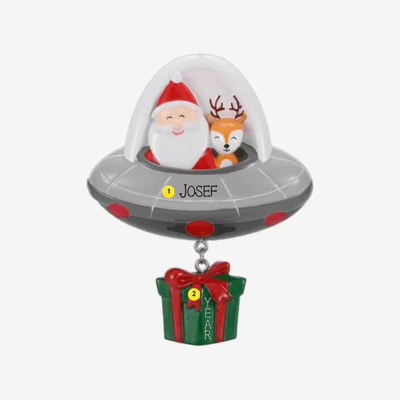 Personalized Santa and reindeer UFO ornament with a name on the flying saucer and space for a year on the present.