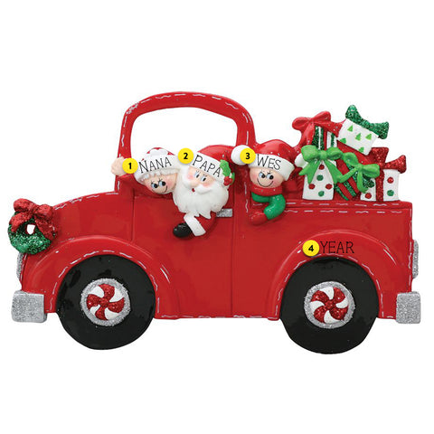 Decorative red truck ornament with Santa Claus and children on a white background
