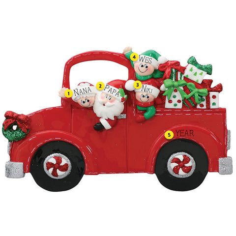 Red Christmas truck ornament with Santa and children on a white background