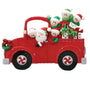 Decorative Christmas ornament of a red truck with Santa Claus and elves on a white background