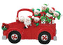 Decorative Christmas ornament of a red truck with Santa and elves on a white background
