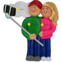 Ornament of a couple holding hands and a selfie stick with personalized names and year.
