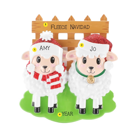 Personalized sheep family of 2 ornament with two sheep in Santa hats by a wooden fence, personalized with example names, phrase, and year.
