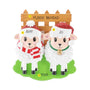 Personalized sheep family of 2 ornament with two sheep in Santa hats by a wooden fence, personalized with example names, phrase, and year.