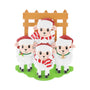 Sheep family of 4 ornament with four sheep in Santa hats by a wooden fence.