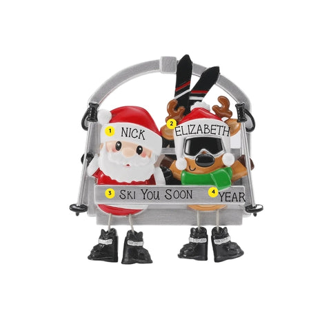 Personalized ski lift couple ornament with example names on the hats, a short phrase on the chairlift bar, and year.