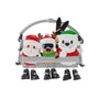 Ski lift ornament with Santa, a reindeer, and a polar bear sitting together with skis, poles, Santa hats, and dangling black boots.