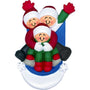 Personalized ornament of three smiling figures riding a blue sled through snow, in matching winter clothes.