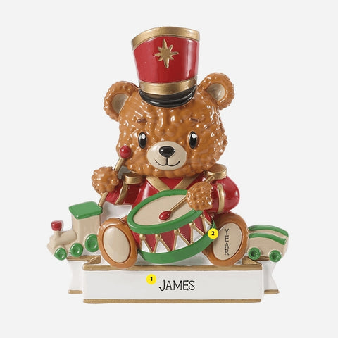 Personalized toy soldier bear ornament with a name on the white base and year added to the bear’s foot.