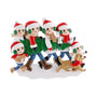 Personalized tree farm family of six ornament with bundled-up family members carrying a Christmas tree and walking with a dog.
