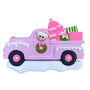  This ornament is a bright pink truck driving through the snow with a decorated Christmas tree and wrapped gifts in the truck bed. 