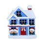 Decorative Christmas house ornament with snow, windows, and a red door.