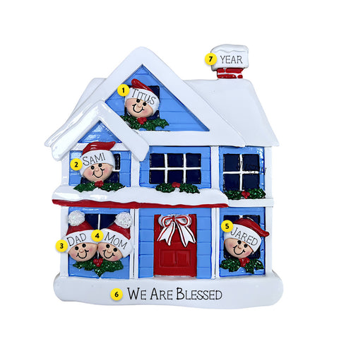 Decorative Christmas house ornament with family members and text on a white background