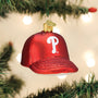 Red baseball cap ornament with a white Phillies logo on a Christmas tree.