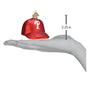 Red baseball cap ornament with a white 'P' logo on a white background, shown on a hand for scale.