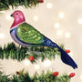Colorful bird ornament on a Christmas tree with lights in the background