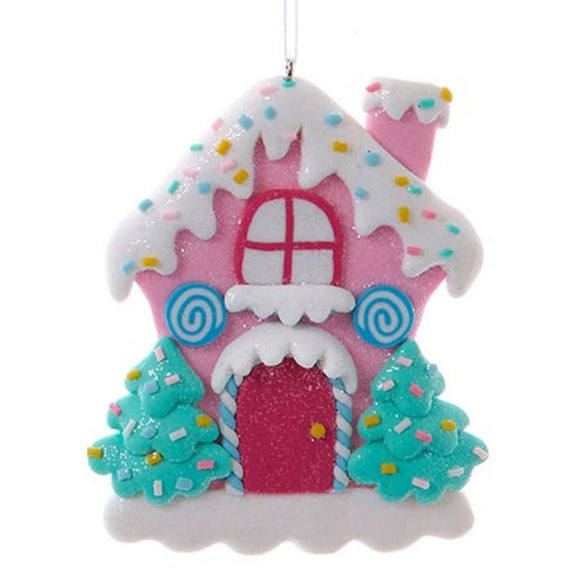 Pink iced candy cottage claydough ornament with blue swirl candy accents, glittery red door, sprinkle roof, and candy-colored trees.